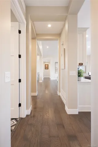 a view of a hallway with wooden floor and closet