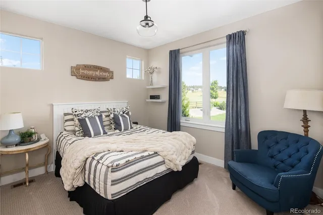 a bedroom with a bed couch and window