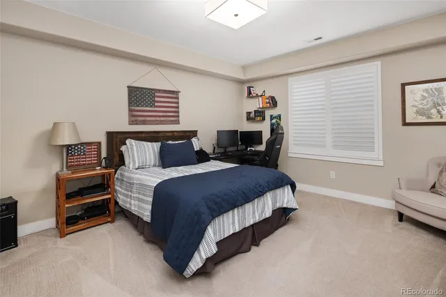 a living room with a bed furniture and a window