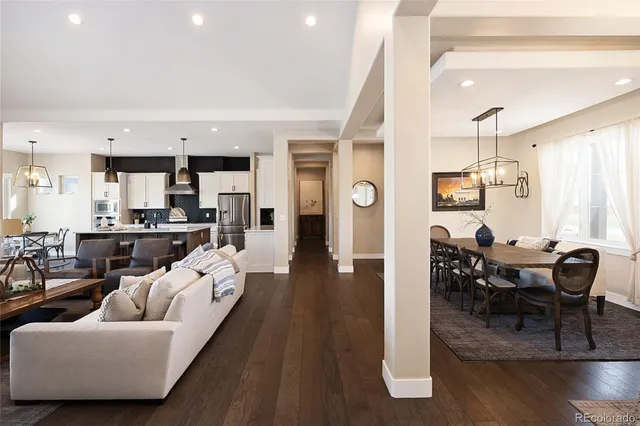 a living room with furniture dining table and a chandelier