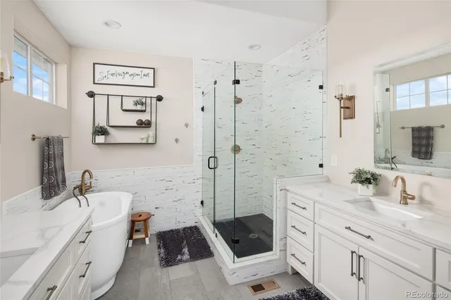 a bathroom with a sink a toilet a vanity and shower