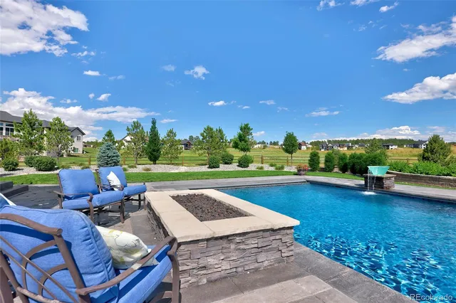a view of a patio with a table and chairs under an umbrella