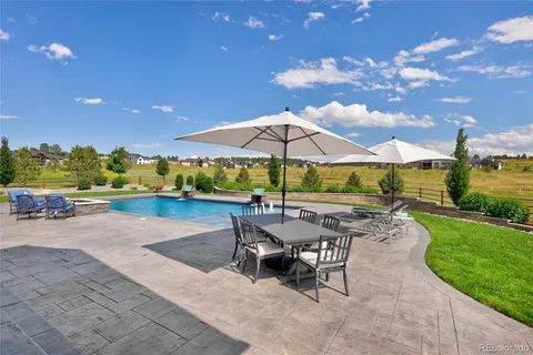 swimming pool view with a seating space