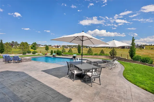 swimming pool view with a seating space