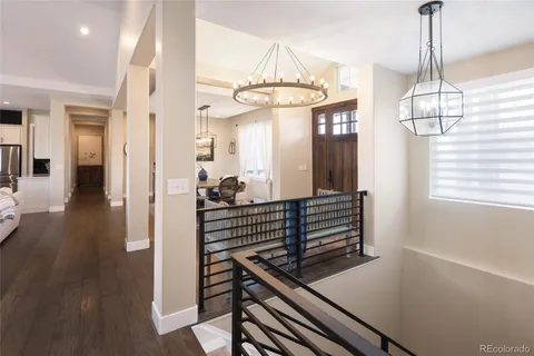a view of a room with wooden floor and staircase