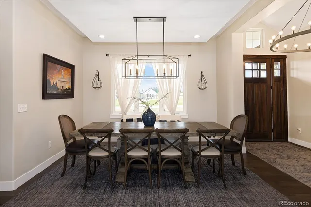 a view of a a dining room with furniture window and wooden floor
