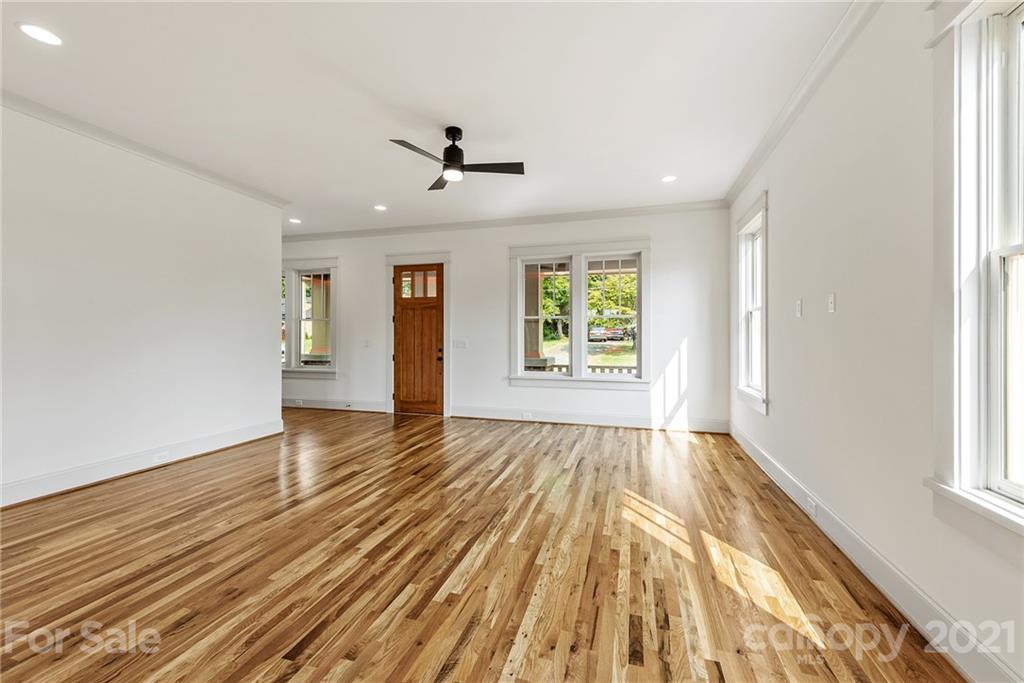 3807 Plainview Road Charlotte, NC 28208 - Photo 12 of 28 wooden floor in an empty room with a window
