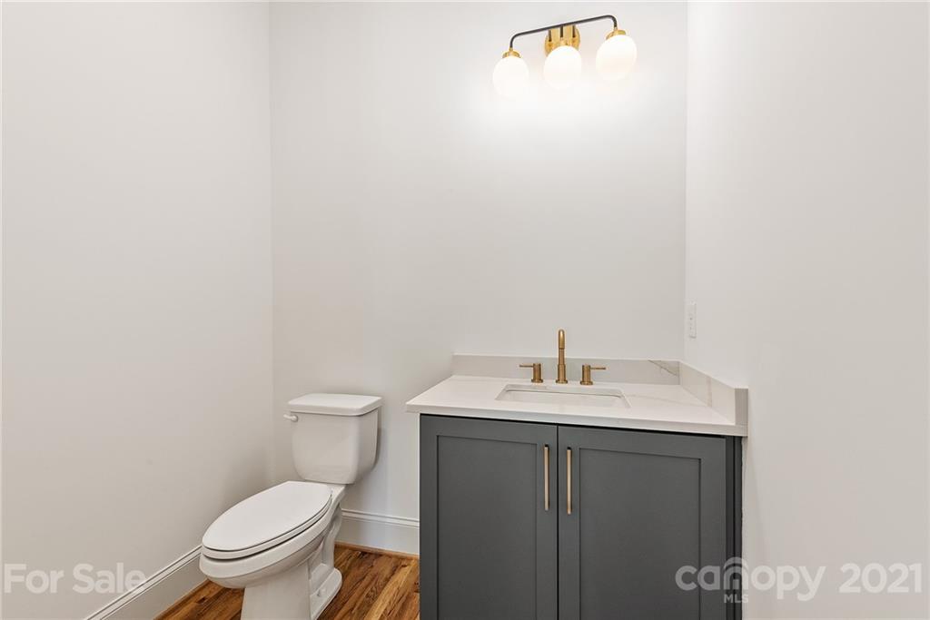 3807 Plainview Road Charlotte, NC 28208 - Photo 14 of 28 a bathroom with a toilet a sink and mirror