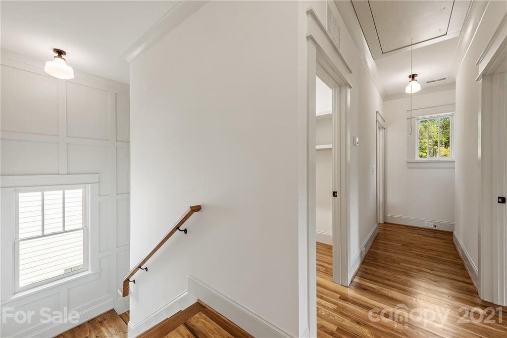 3807 Plainview Road Charlotte, NC 28208 - Photo 15 of 28 a view of a hallway with wooden floor and staircase