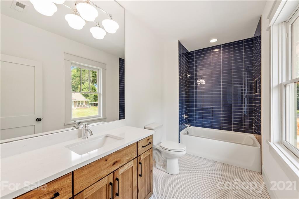 3807 Plainview Road Charlotte, NC 28208 - Photo 22 of 28 a bathroom with a bathtub shower sink vanity mirror and toilet