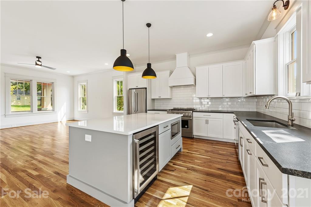 3807 Plainview Road Charlotte, NC 28208 - Photo 6 of 28 a kitchen with stainless steel appliances granite countertop a sink a stove and a wooden floors