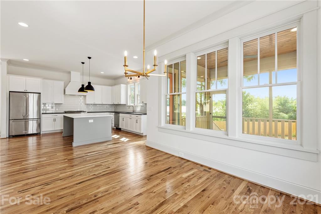 3807 Plainview Road Charlotte, NC 28208 - Photo 8 of 28 a view of large kitchen with wooden floor and windows
