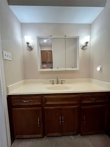 a bathroom with a tub sink and a mirror
