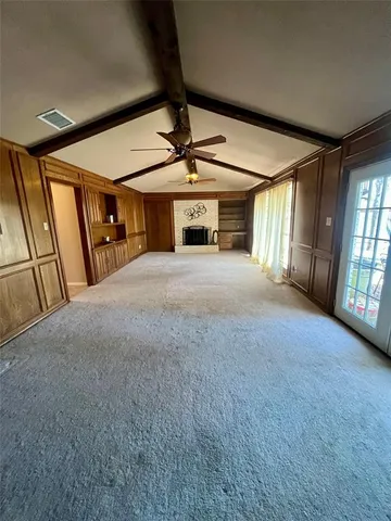 a view of an empty room with windows