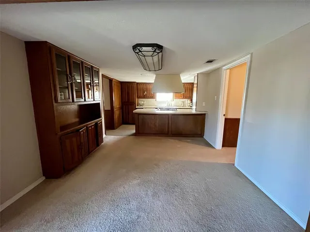 a kitchen with granite countertop a refrigerator and a stove top oven
