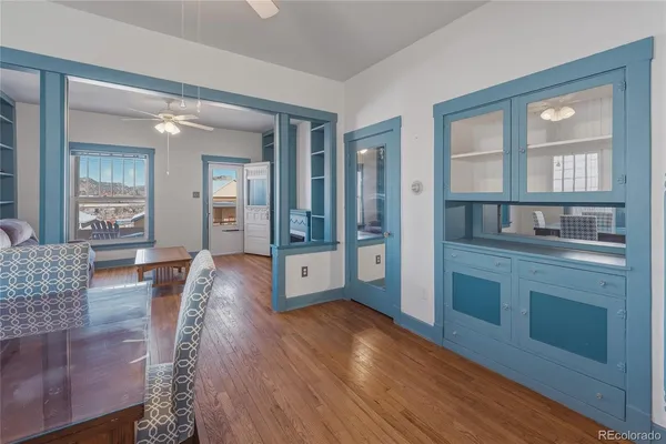 a view of an entryway with wooden floor and a livingroom