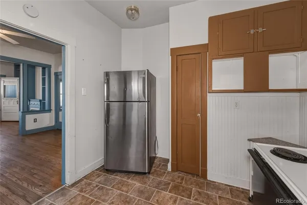 a kitchen with stainless steel appliances granite countertop a refrigerator and a stove