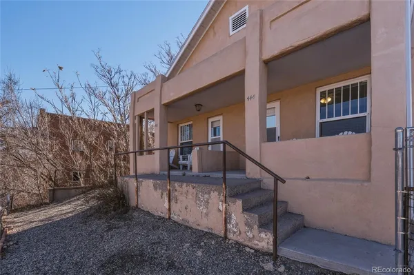 a backyard of a house with table and chairs