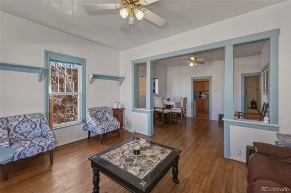 a living room with furniture and wooden floor