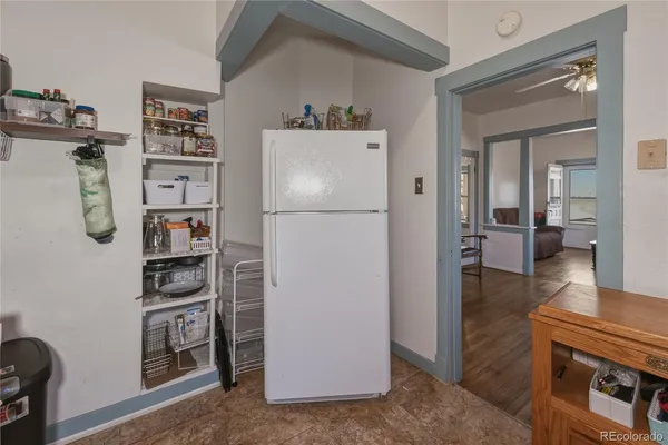 a white refrigerator freezer and a stove sitting inside of a kitchen