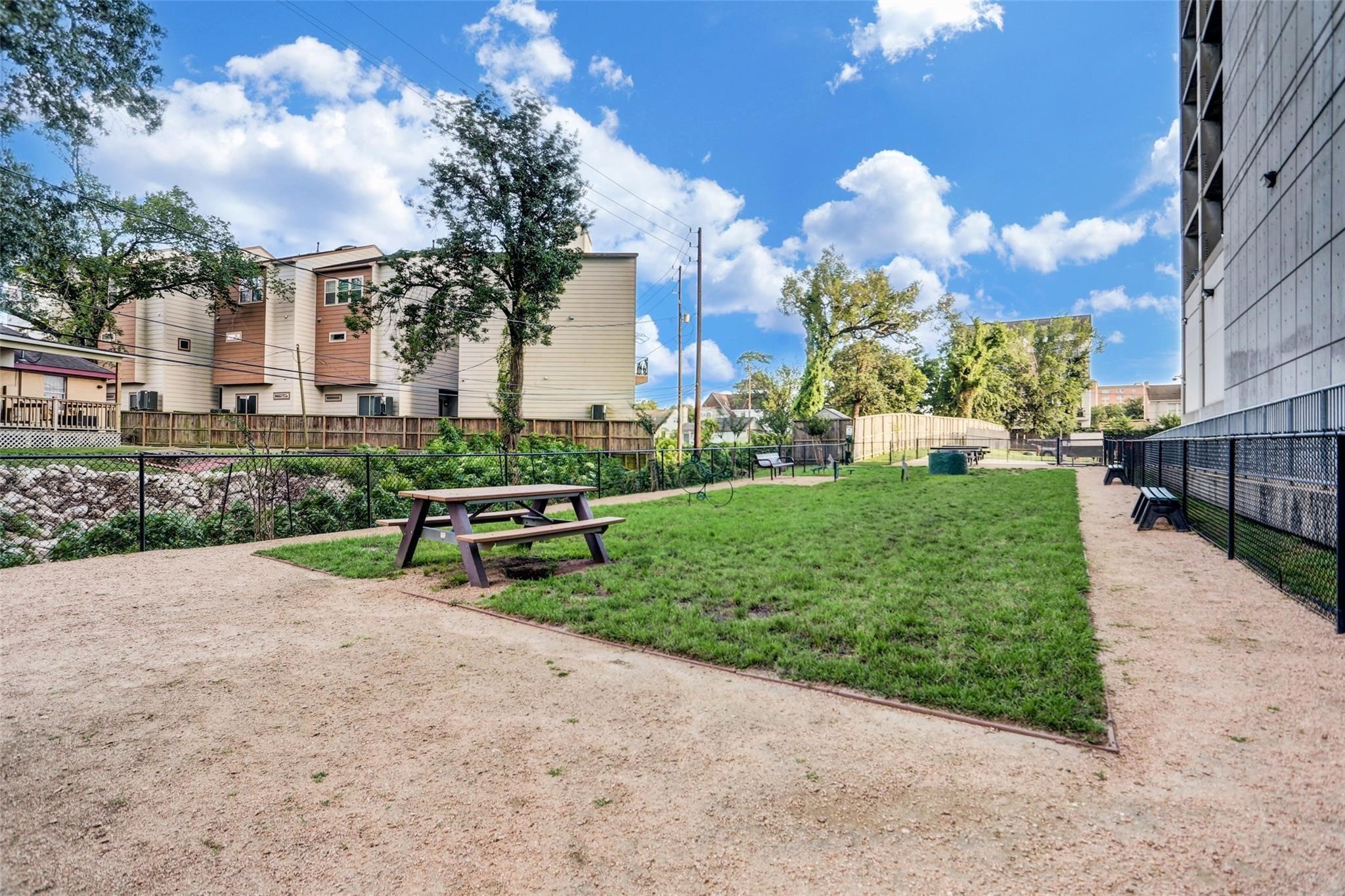 5925 Almeda Road, Unit 11315 Houston, TX 77004 - Photo 24 of 31 Fenced dog park with open green space, benches, and picnic tables gives residents a convenient spot for pets to play and neighbors to connect.