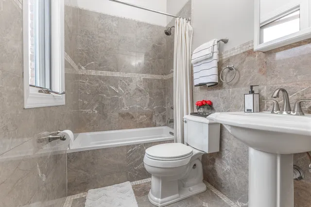 a bathroom with a sink toilet and shower