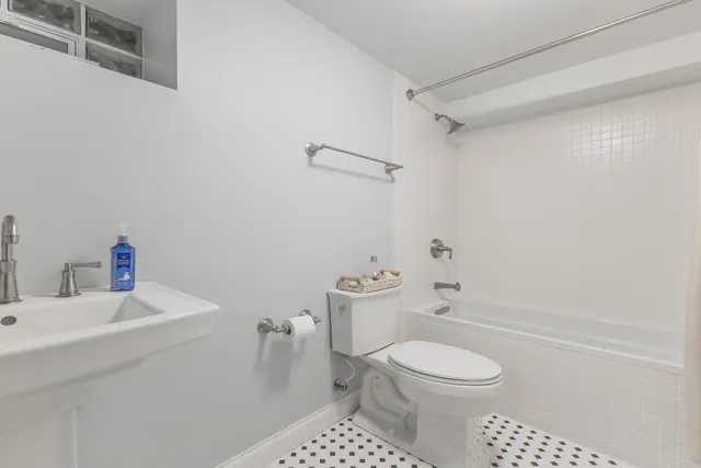 a bathroom with a toilet a sink and a shower