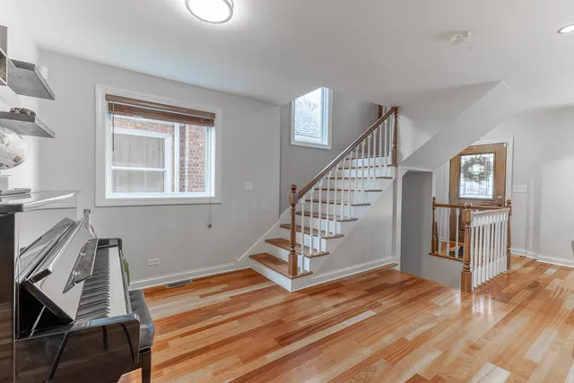a view of a room with wooden floor staircase and windows
