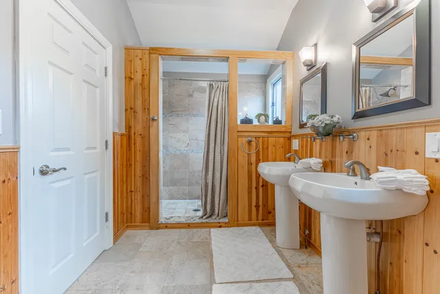 a bathroom with a sink a mirror and a shower