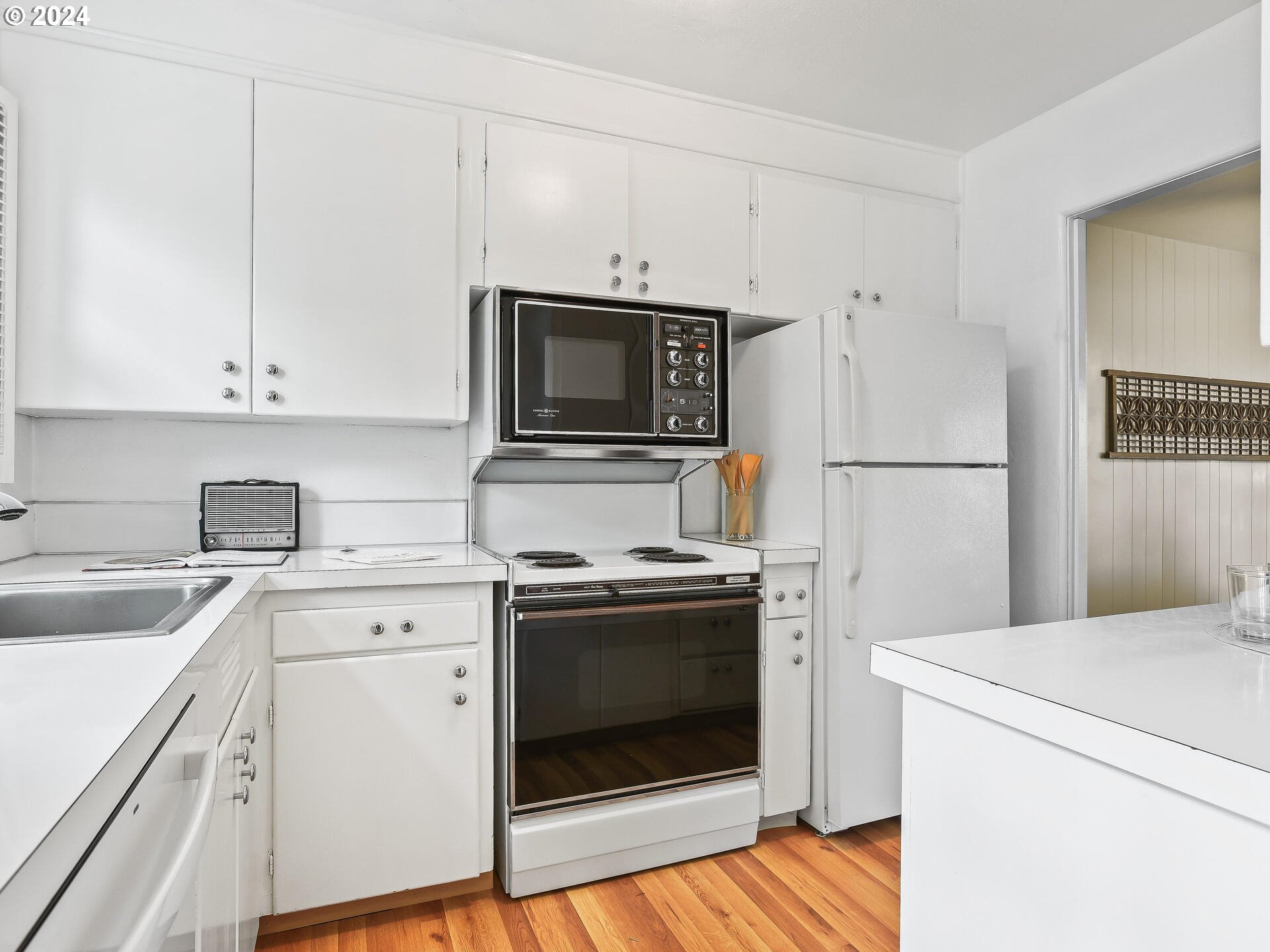 6937 Northeast Broadway Portland, OR 97213 - Photo 17 of 48 a kitchen with cabinets stainless steel appliances and sink