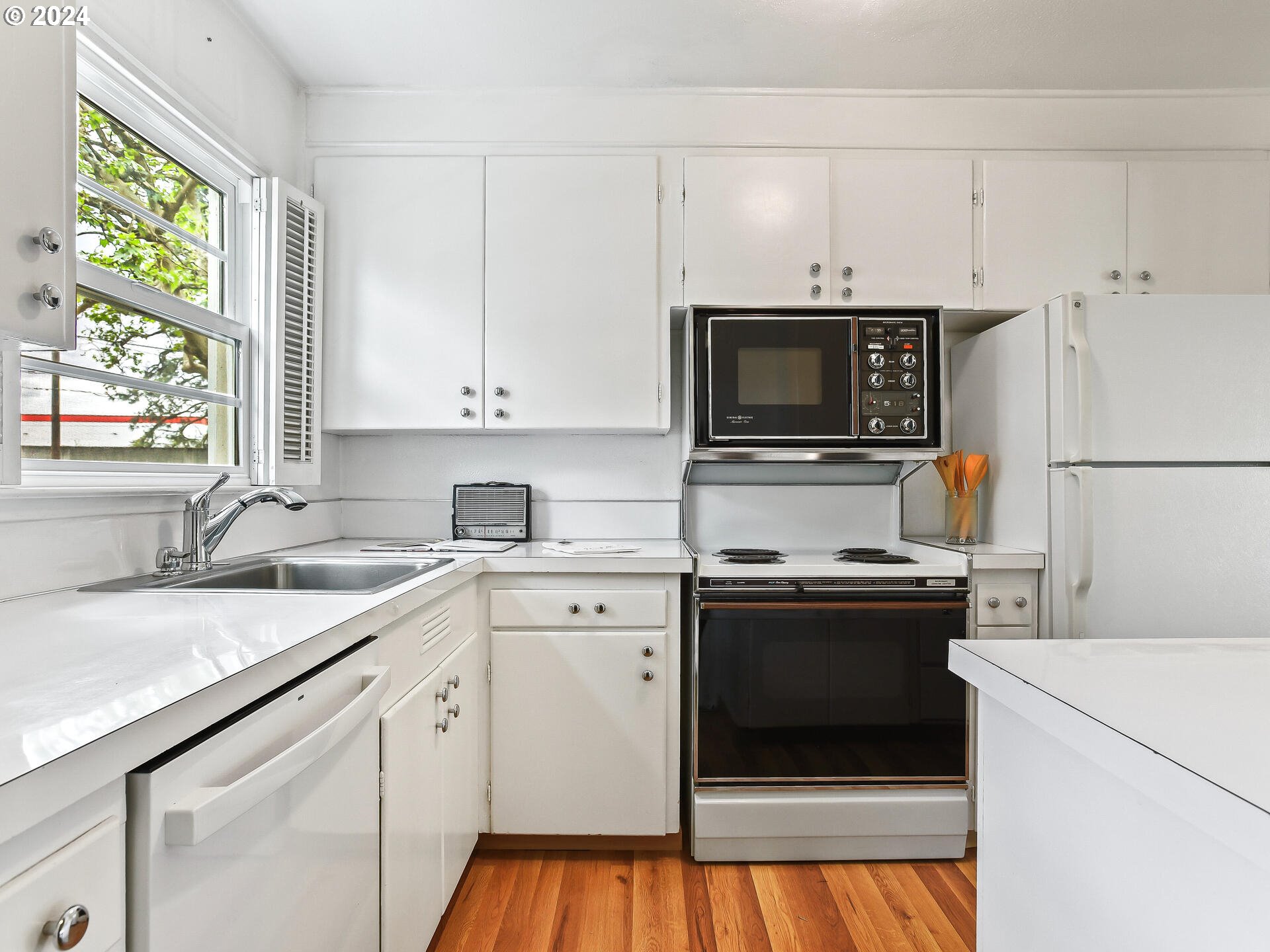 6937 Northeast Broadway Portland, OR 97213 - Photo 18 of 48 a kitchen with appliances a sink and a window