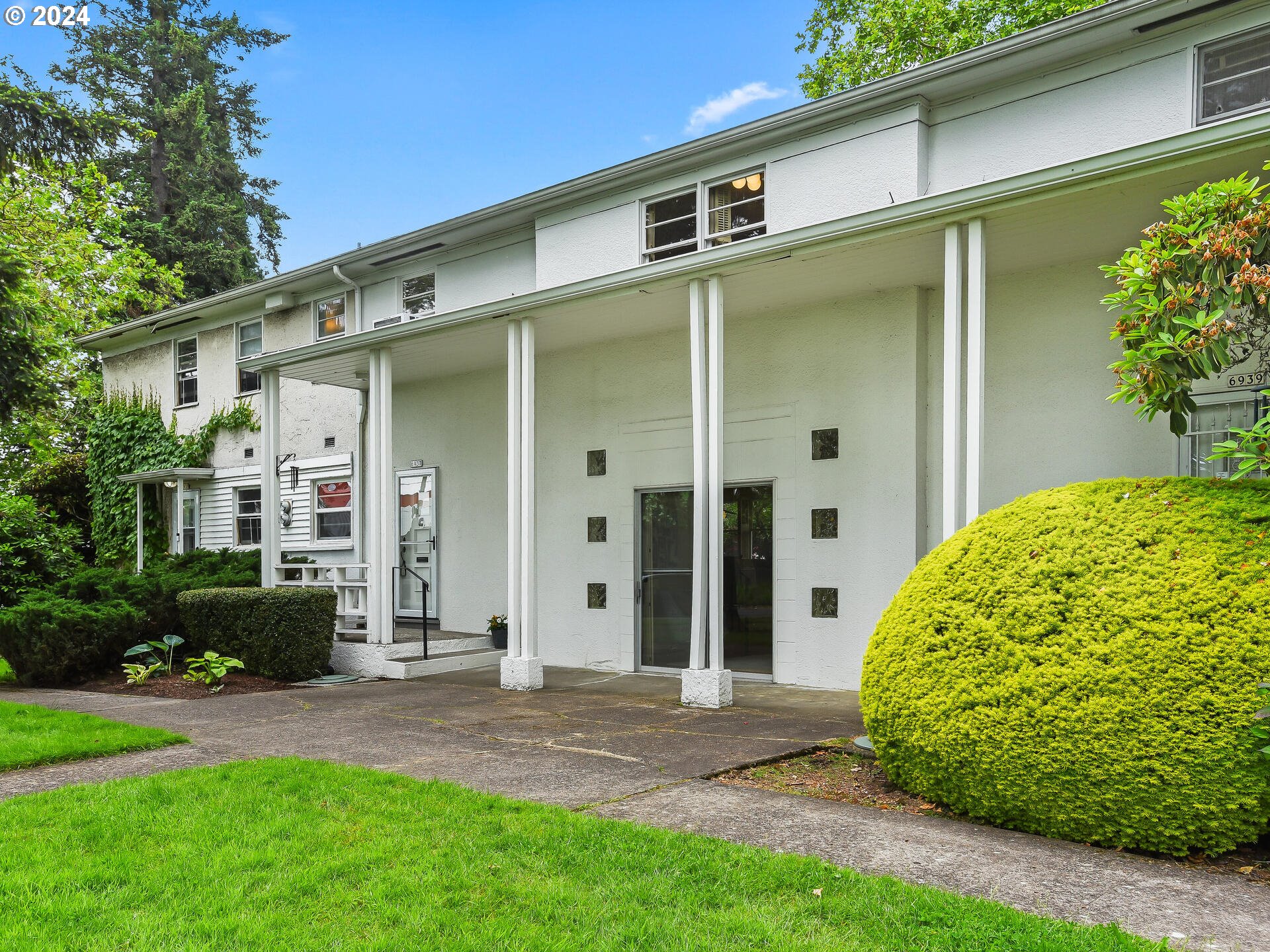6937 Northeast Broadway Portland, OR 97213 - Photo 2 of 48 a front view of a house with garden