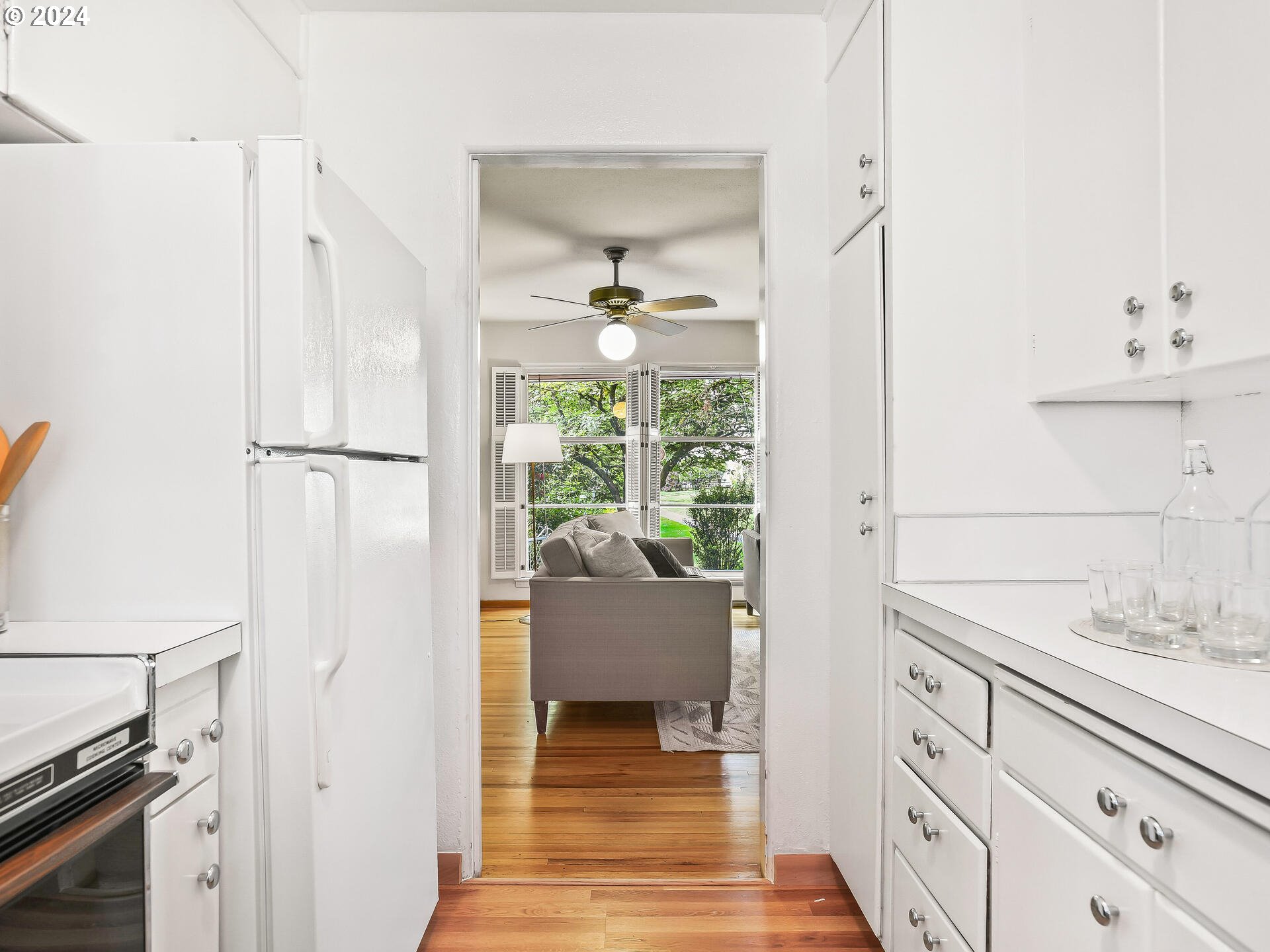 6937 Northeast Broadway Portland, OR 97213 - Photo 21 of 48 a hallway with white doors and chandelier