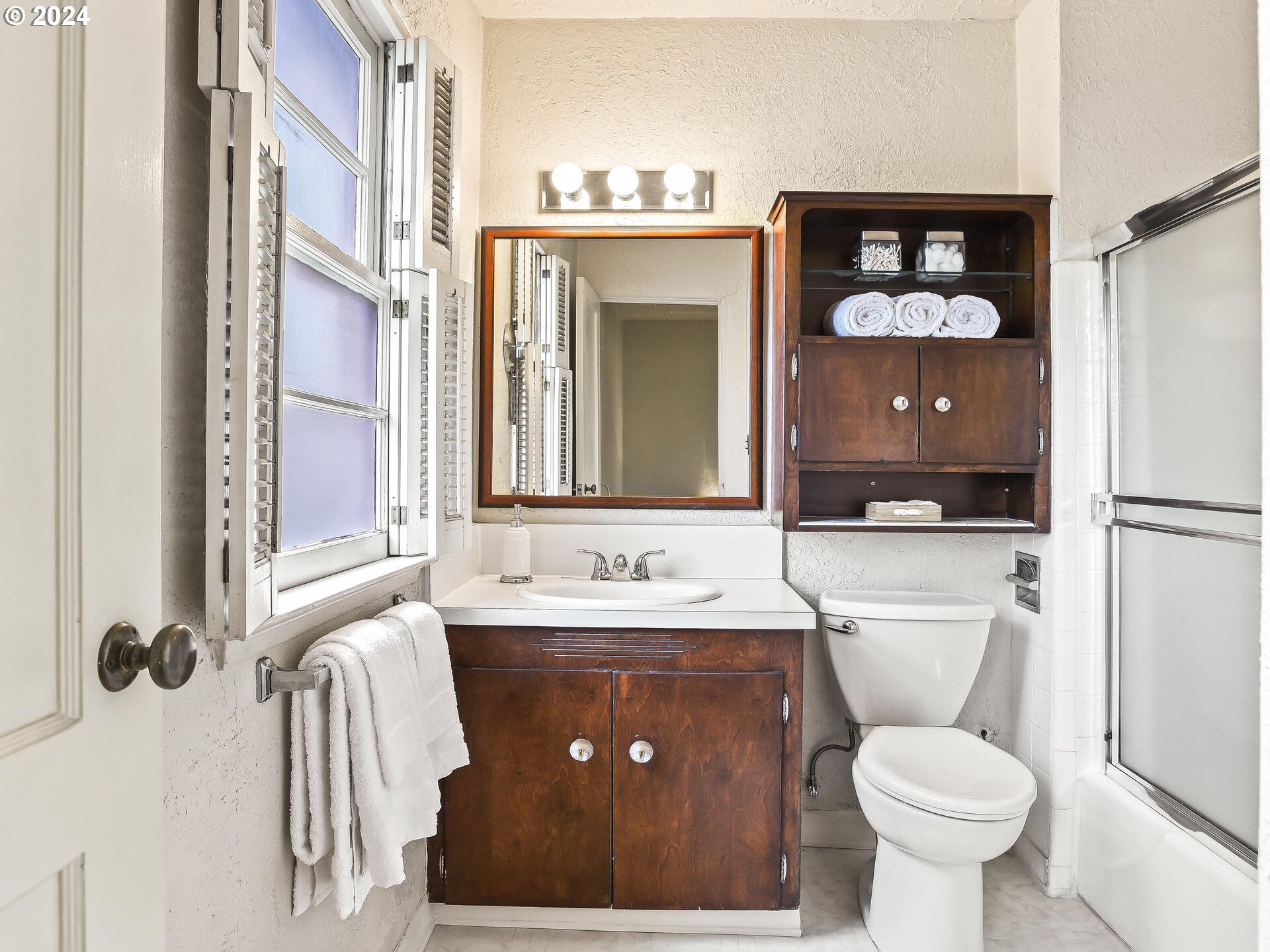6937 Northeast Broadway Portland, OR 97213 - Photo 24 of 48 a bathroom with a toilet sink and mirror