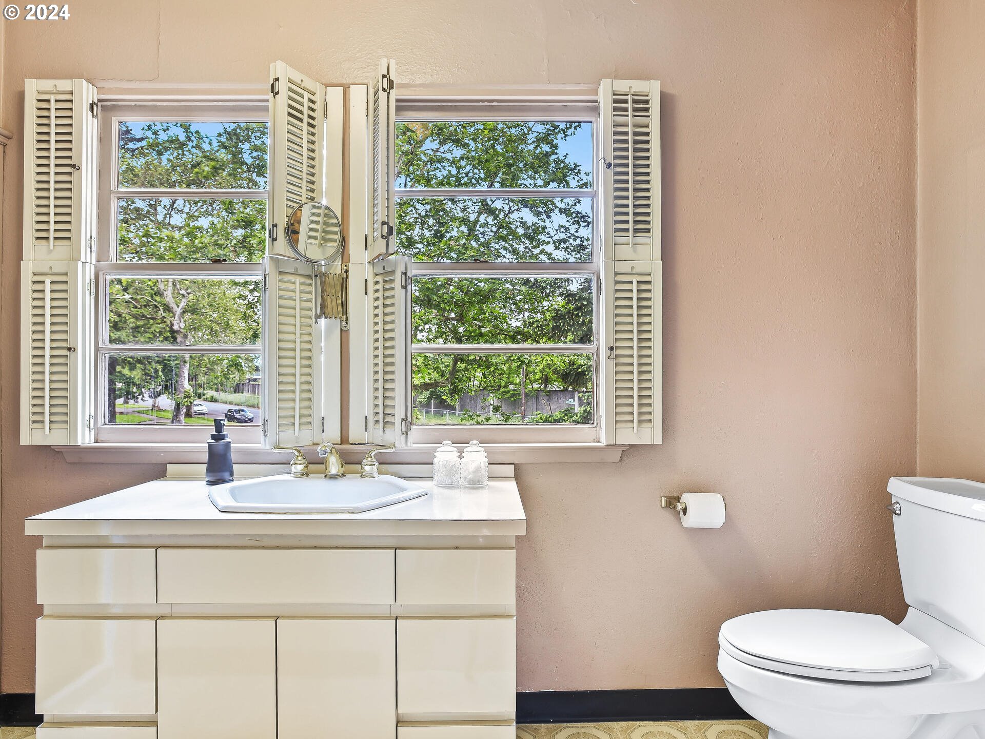 6937 Northeast Broadway Portland, OR 97213 - Photo 36 of 48 a bathroom with a sink a toilet and a window