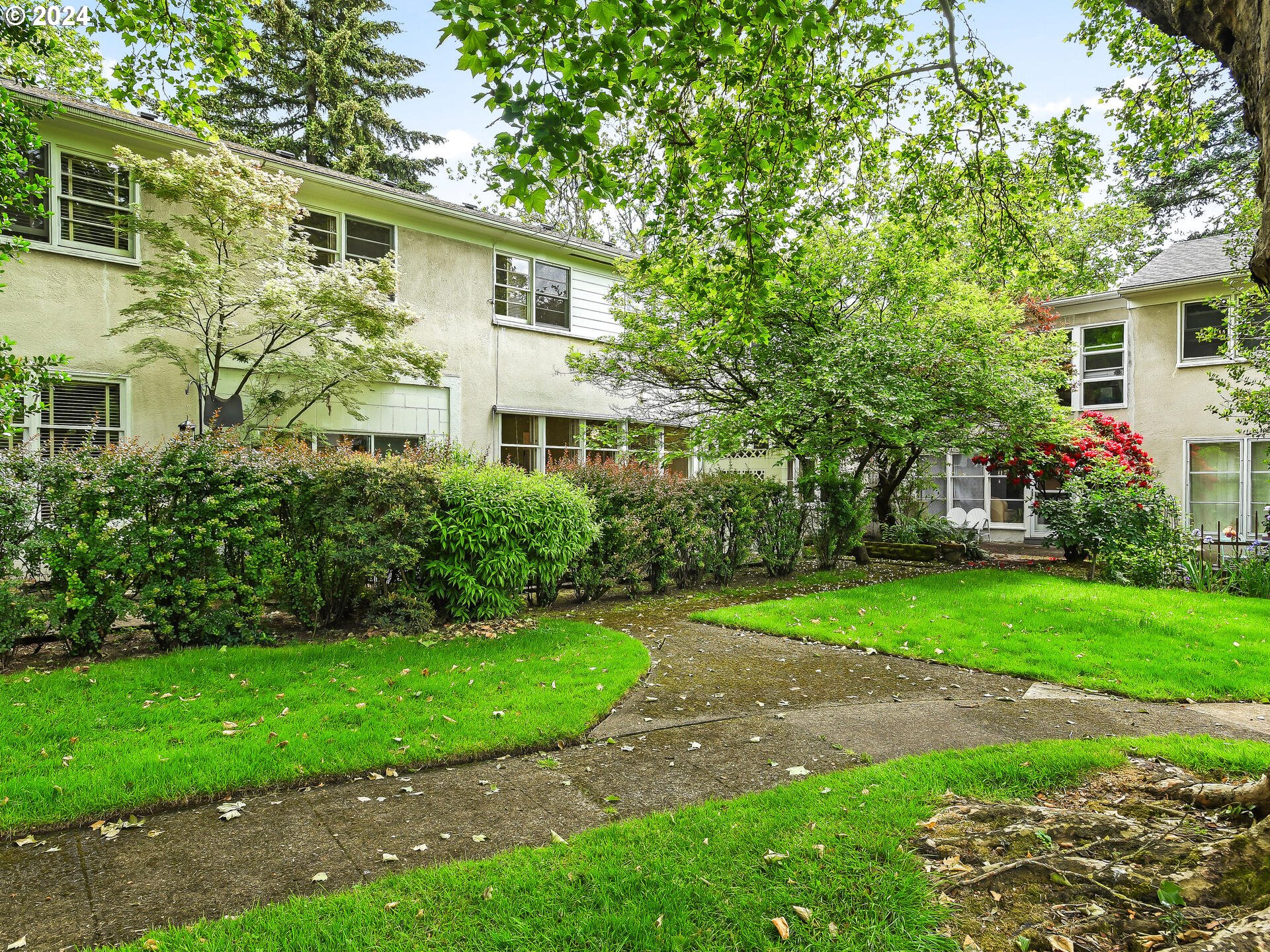 6937 Northeast Broadway Portland, OR 97213 - Photo 47 of 48 a front view of a house with a yard and trees