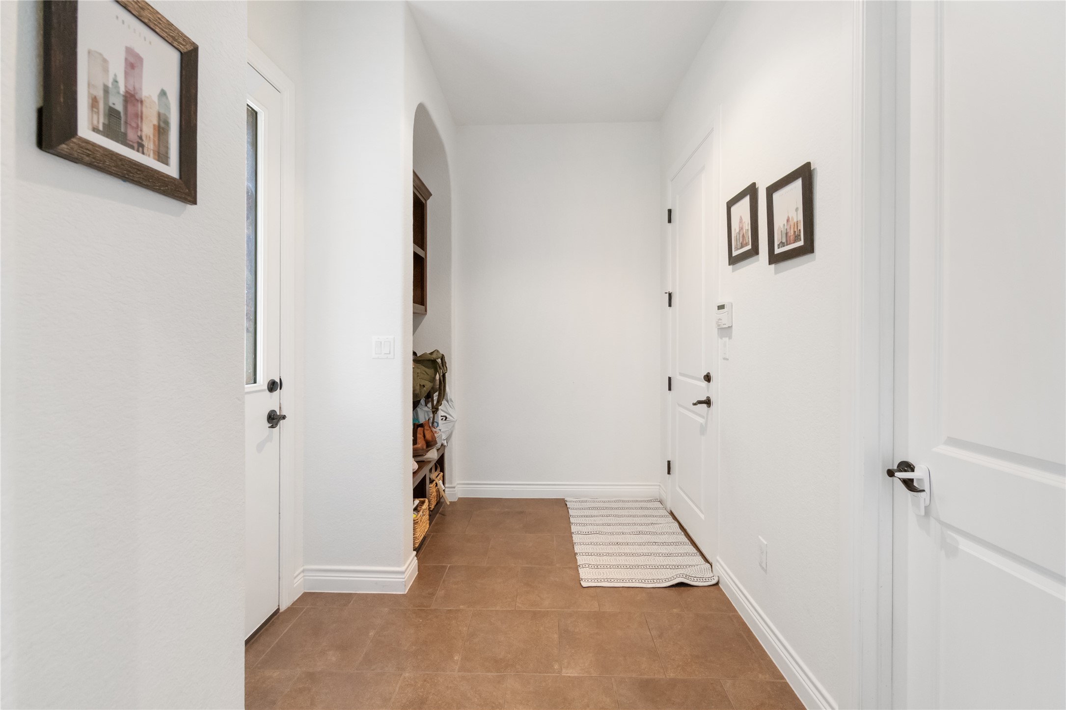 415 Bitterroot Lane Austin, TX 78737 - Photo 20 of 25 A well-lit entry with warm tile flooring and an inviting alcove for organization.