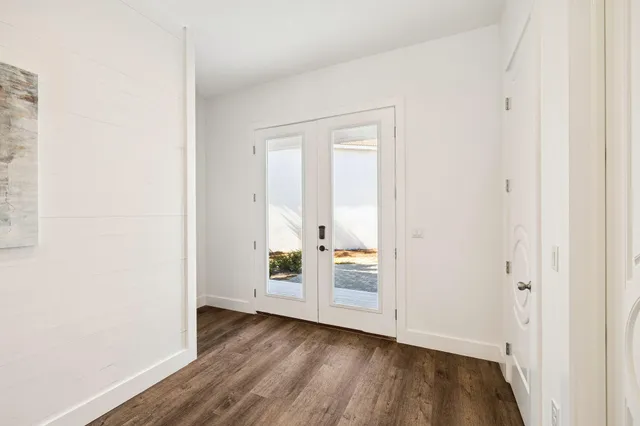 an aerial view of residential houses with outdoor space and trees