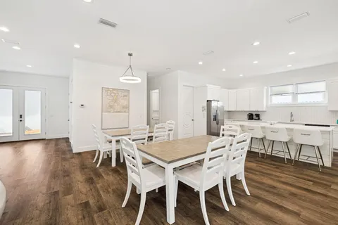 a view of a swimming pool with a patio and a yard