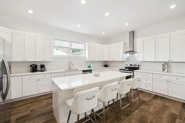 an aerial view of residential houses with outdoor space and trees