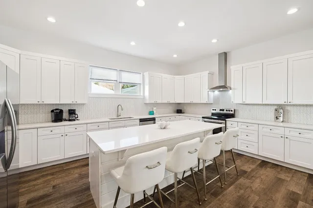 a en suite bathroom with a granite countertop sink and a mirror