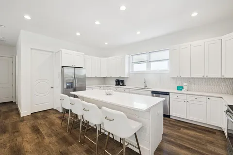a view of a hallway with wooden floor and closet