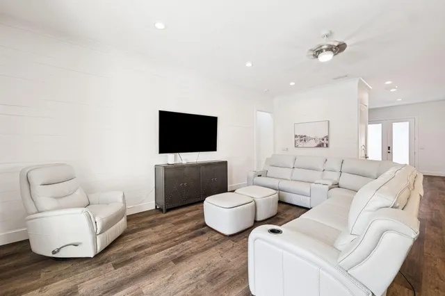 a view of a livingroom with wooden floor and a flat screen tv