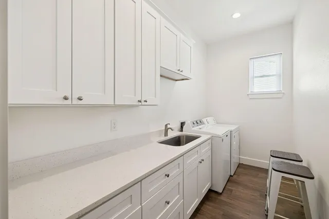 a bathroom with a granite countertop sink a toilet and shower