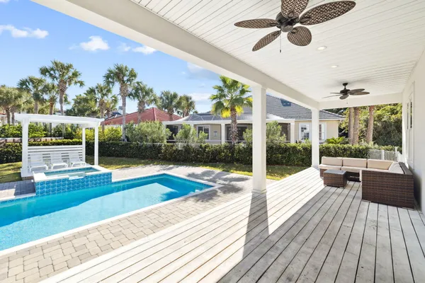 a spacious bedroom with a bed and a chandelier