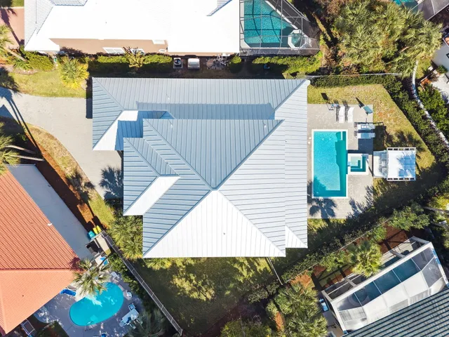 an aerial view of a house with a yard