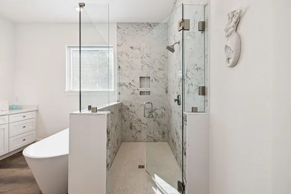 a bathroom with a granite countertop sink a toilet and shower