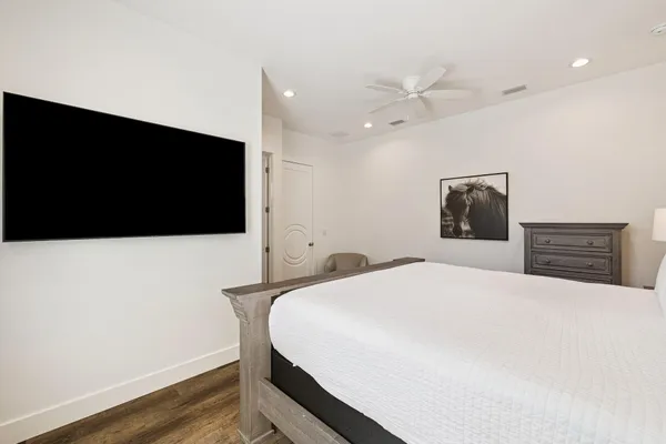 a bedroom with a bed and a flat screen tv