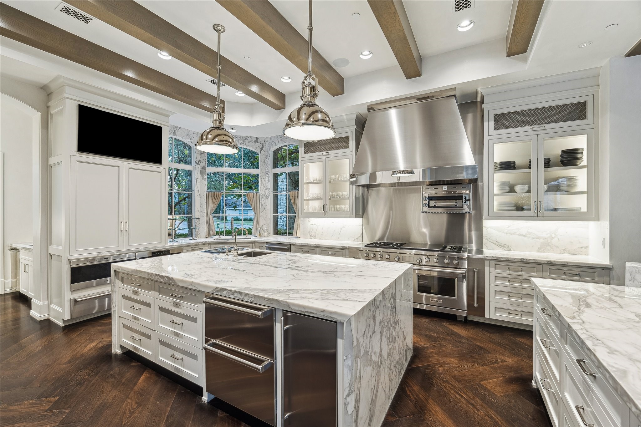 220 Merrie Way Lane Houston, TX 77024 - Photo 11 of 50 The kitchen is equipped with dual Sub-Zero refrigerators, refrigerator drawers, and a full professional Wolf suite—range, dual ovens, convection oven, steamer, and salamander broiler. Smart storage and a concealed scullery keep the workspace beautifully streamlined.