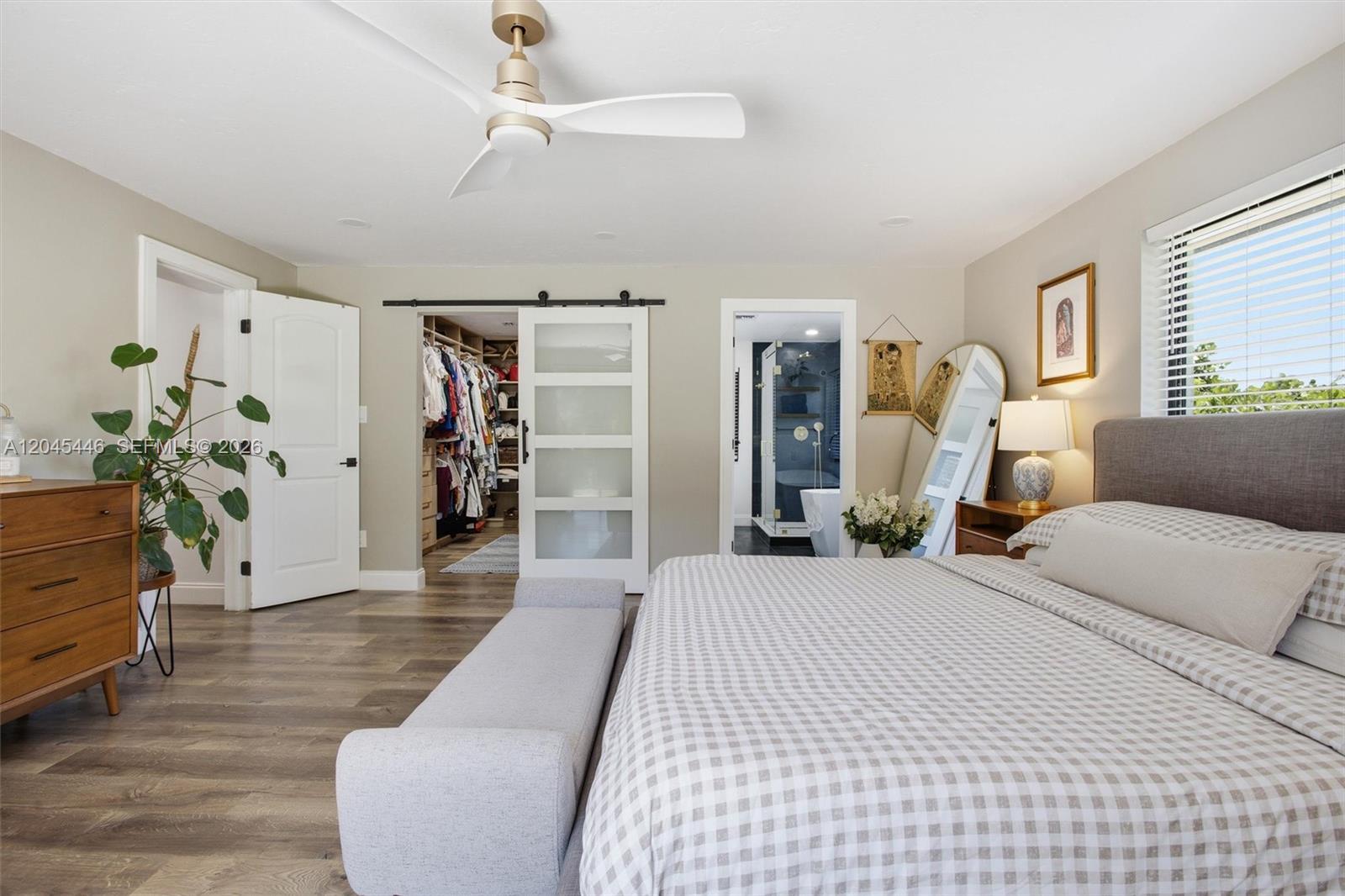 8440 Southwest 180th Street Palmetto Bay, FL 33157 - Photo 23 of 54 a bedroom with a large bed and a chandelier